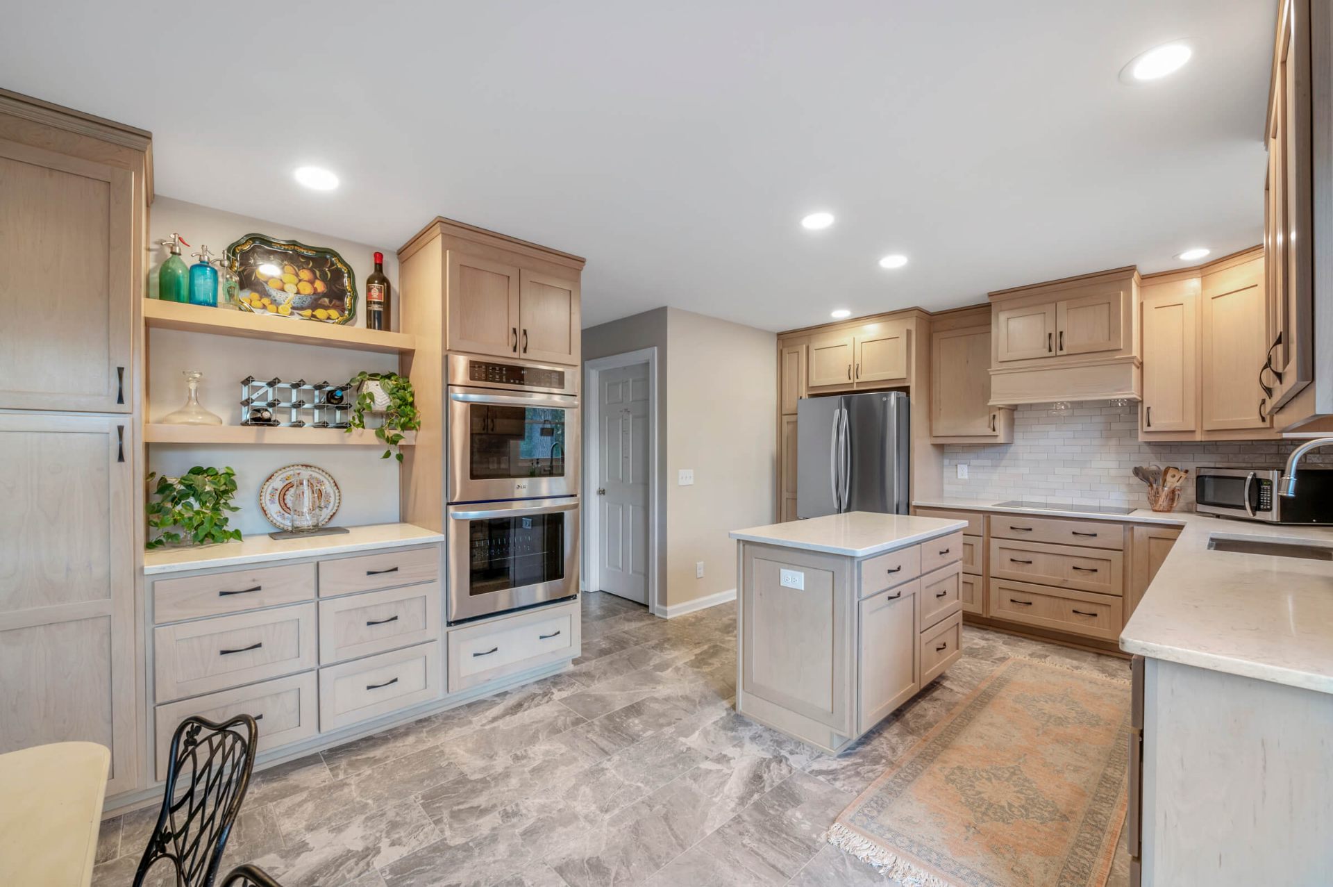 Fuquay-Varina NC kitchen remodel with natural maple shaker cabinets, LG double wall oven, and gray marble tile flooring