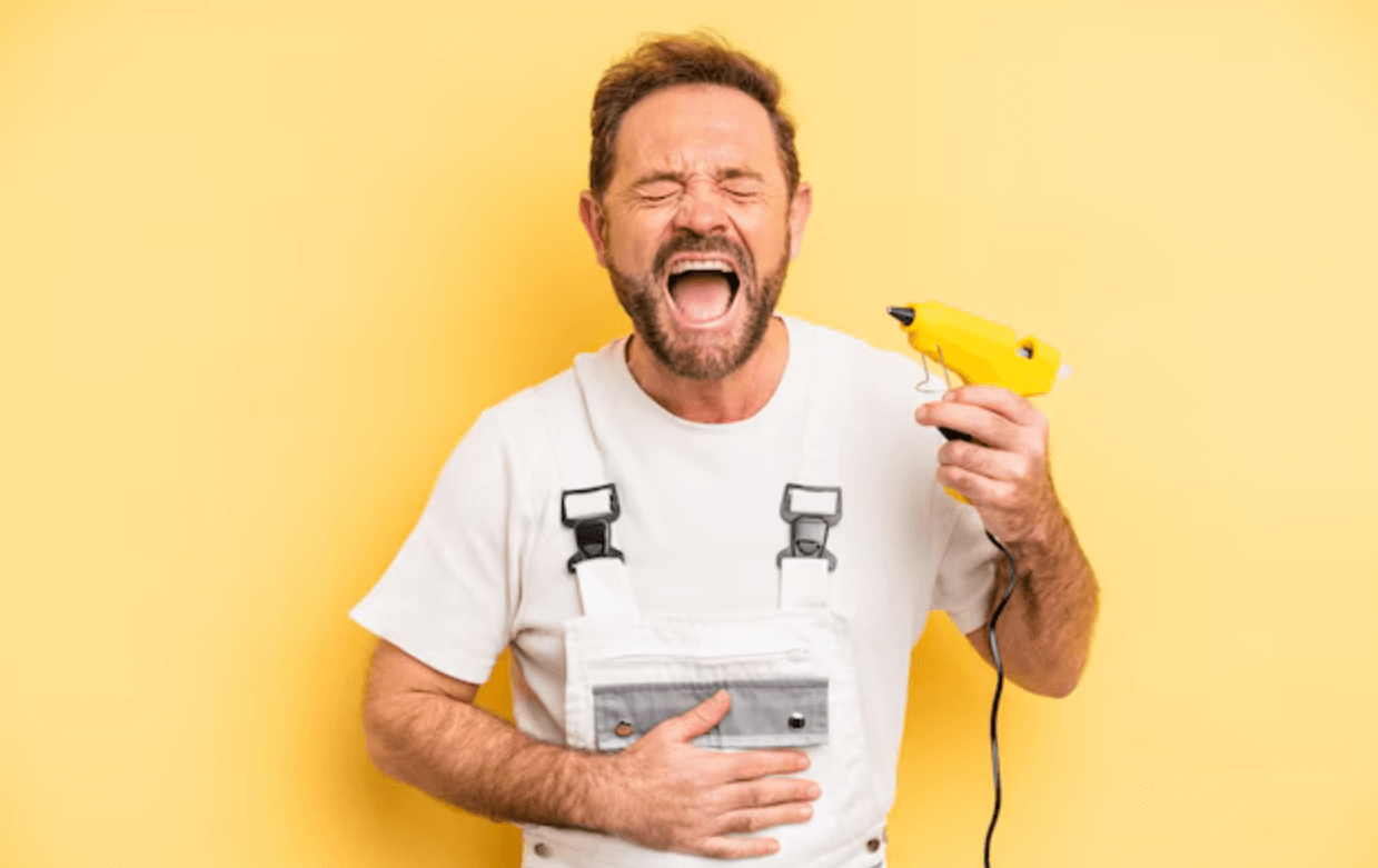 100 handyman jokes with a guy holding yellow glue gun