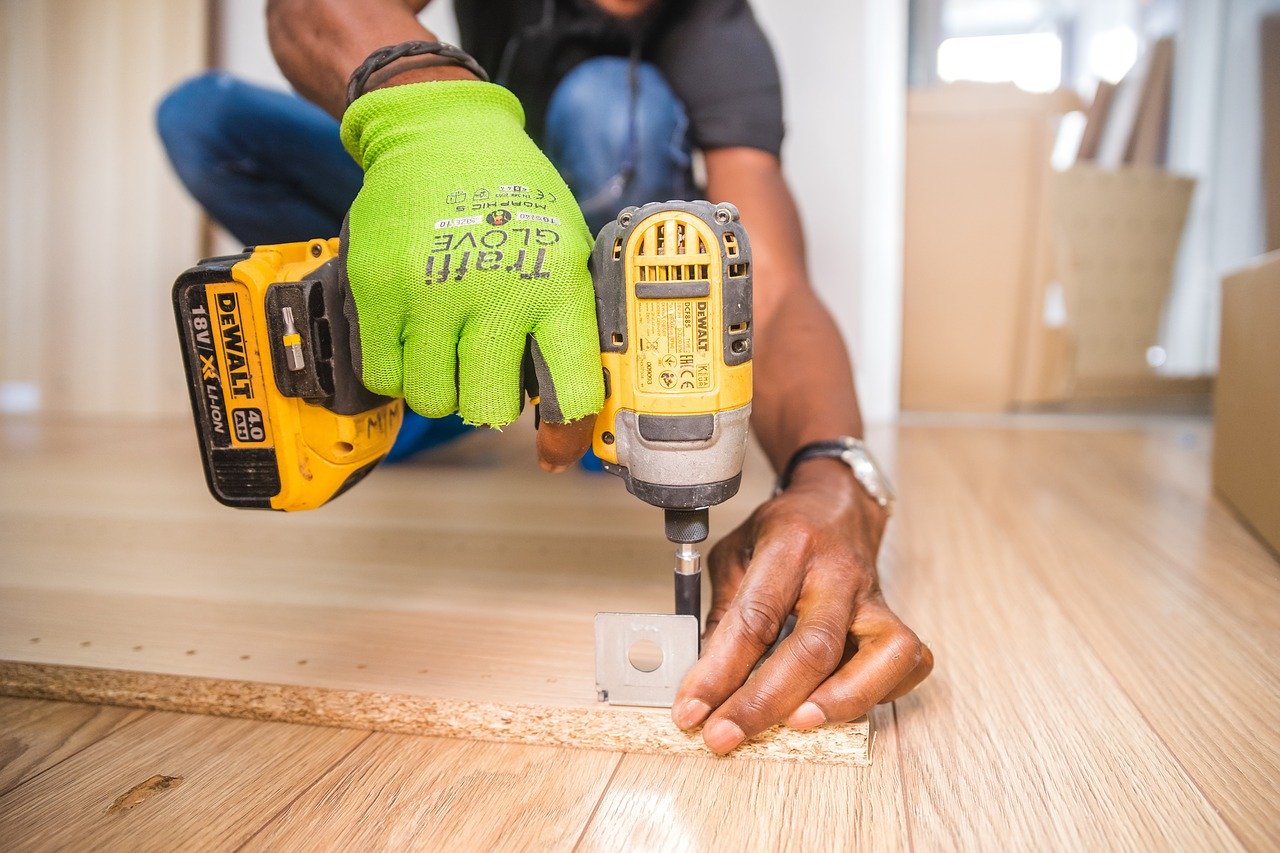 Home project contractor with drill and cabinet piece