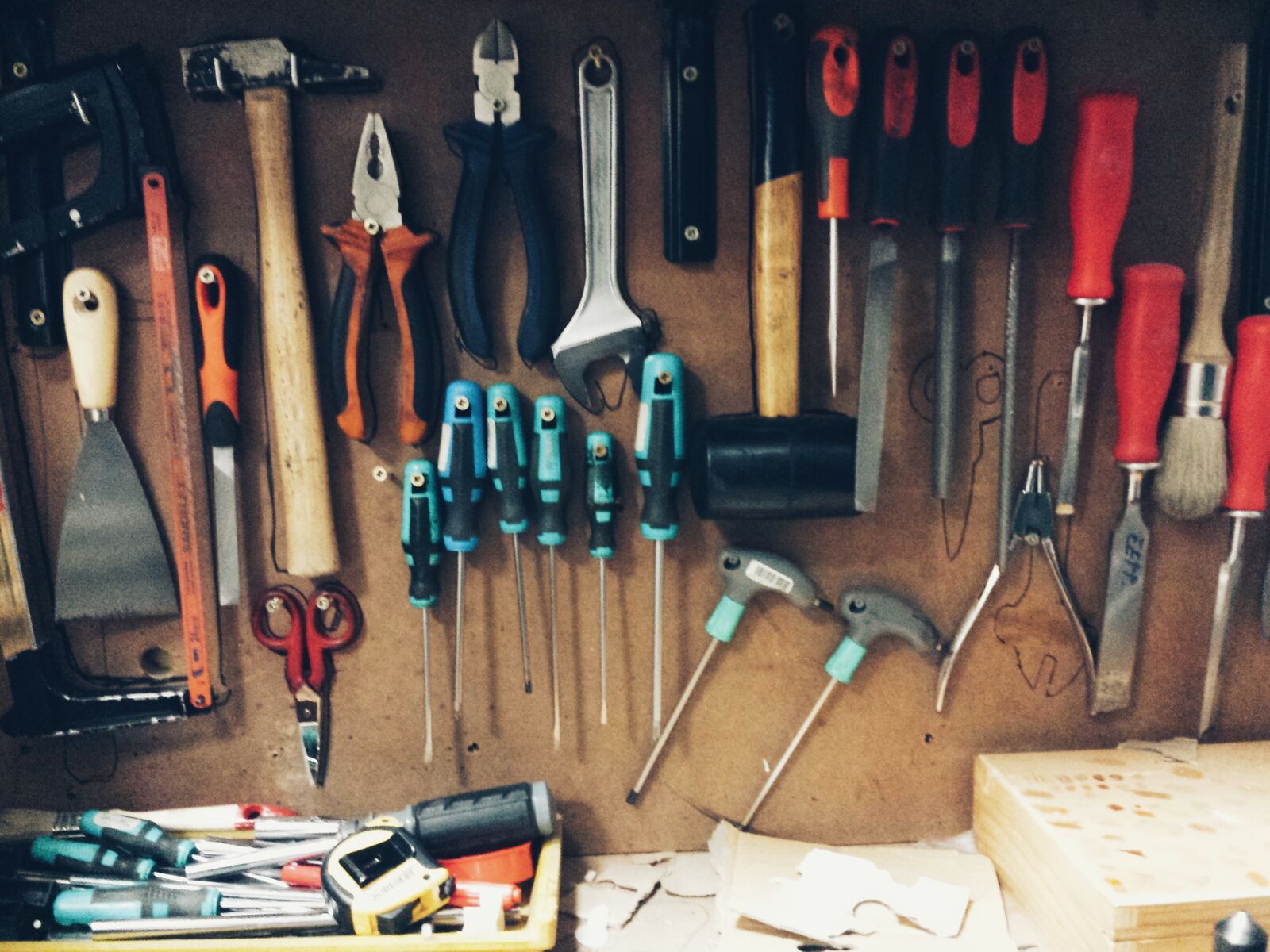 handyman tools hanging on brown wall