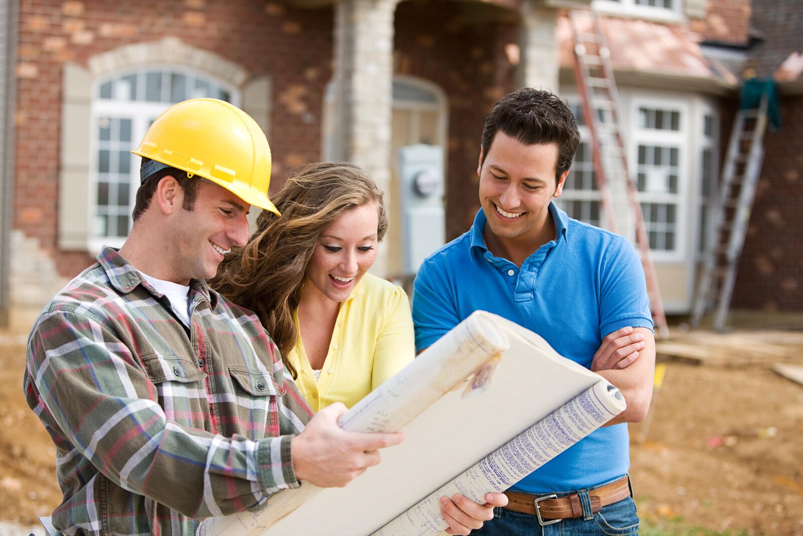 Remodeling contractor showing blueprint to people