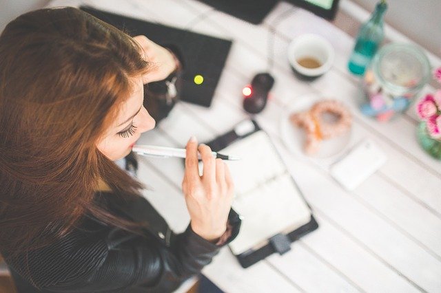 Prioritizing remodel costs with woman and notepad