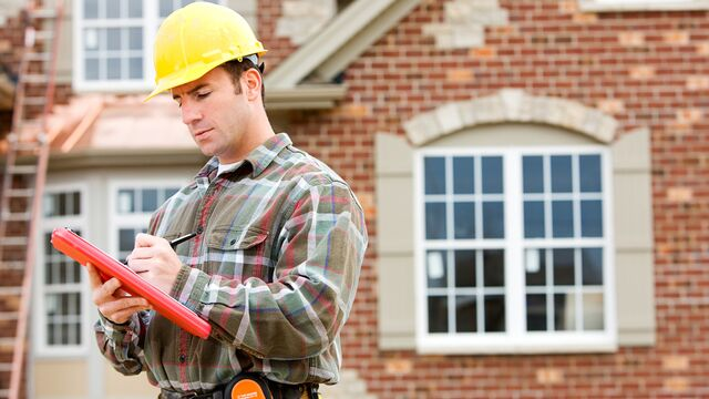 home builder contractor looking over list