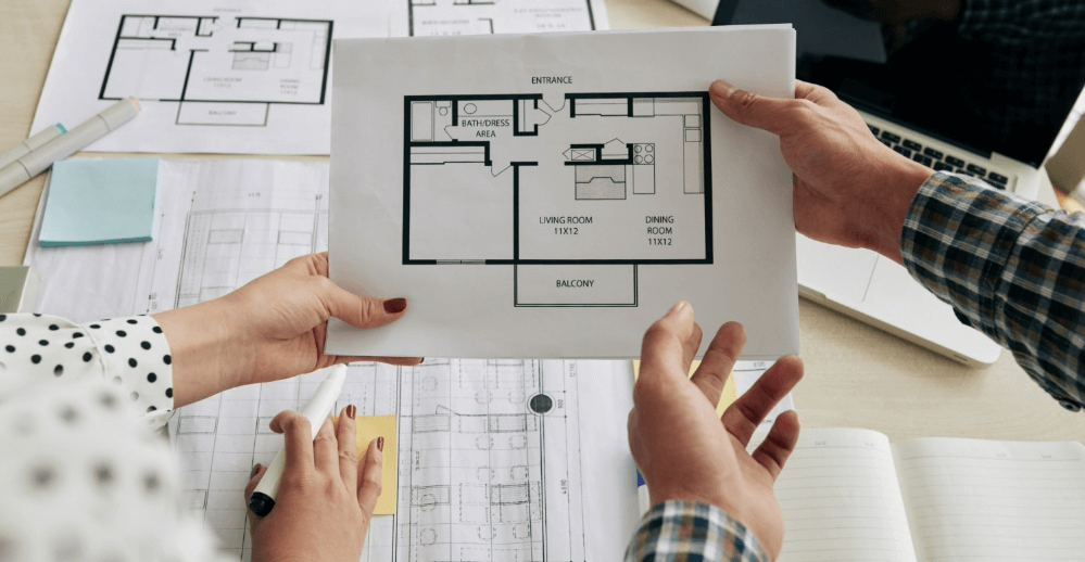 Close-up view of contractor reviewing kitchen renovation plans